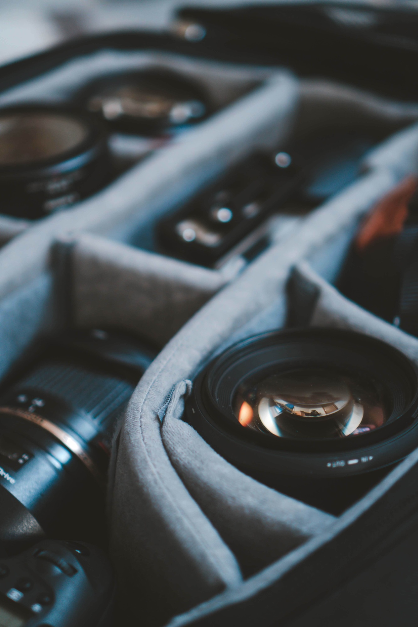 Selective focus shot of digital camera lenses in a lens bag